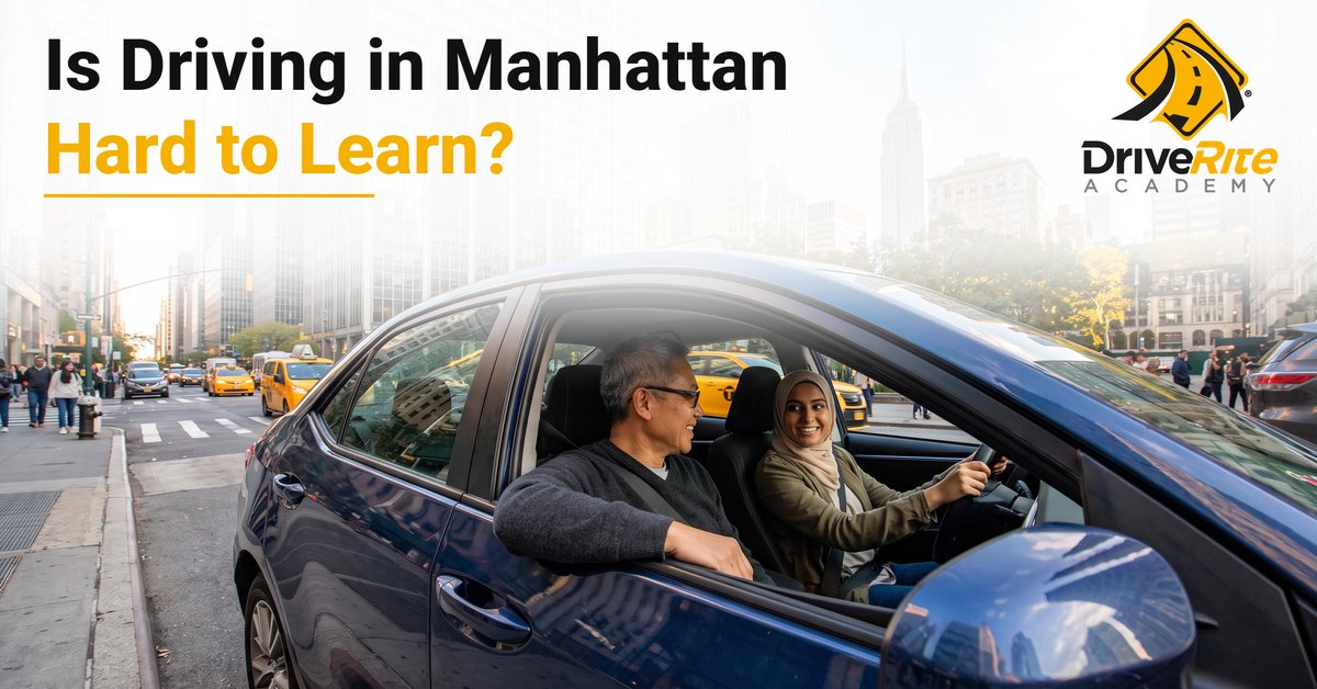 A smiling driving instructor in the passenger seat and an adult student behind the wheel of a blue sedan on a sunny Midtown Manhattan avenue, with yellow taxis and the Empire State Building in the distance, under the title Is Driving in Manhattan Hard to Learn?