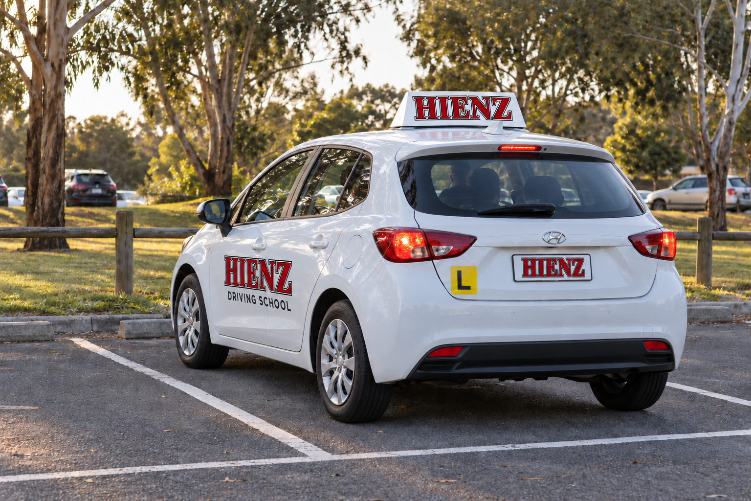 Illustration of a white HIENZ learner car positioned inside a marked parking bay
