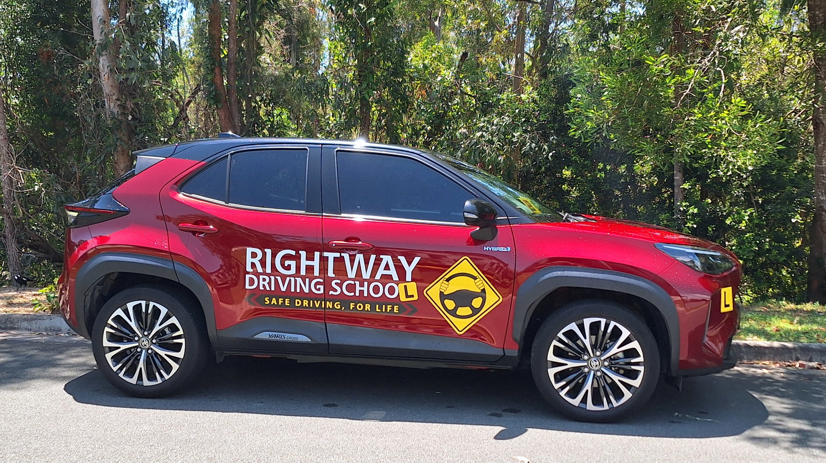 Red Rightway-branded SUV photographed side-on with green foliage behind.