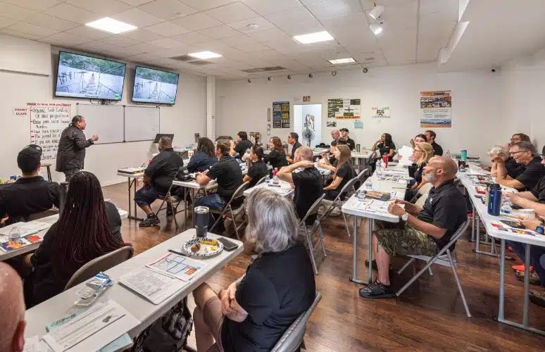 This is an arizona driver education classroom full of students learning from a patient and kind instructor.