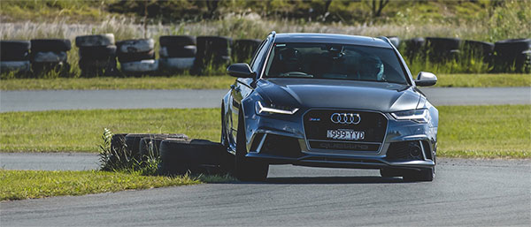 A Precision and Stunt Driver driving around tyres on a track.