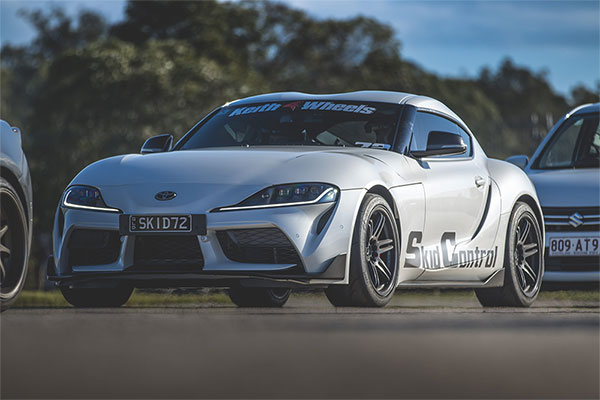 A silver film and stunt hire sports car.