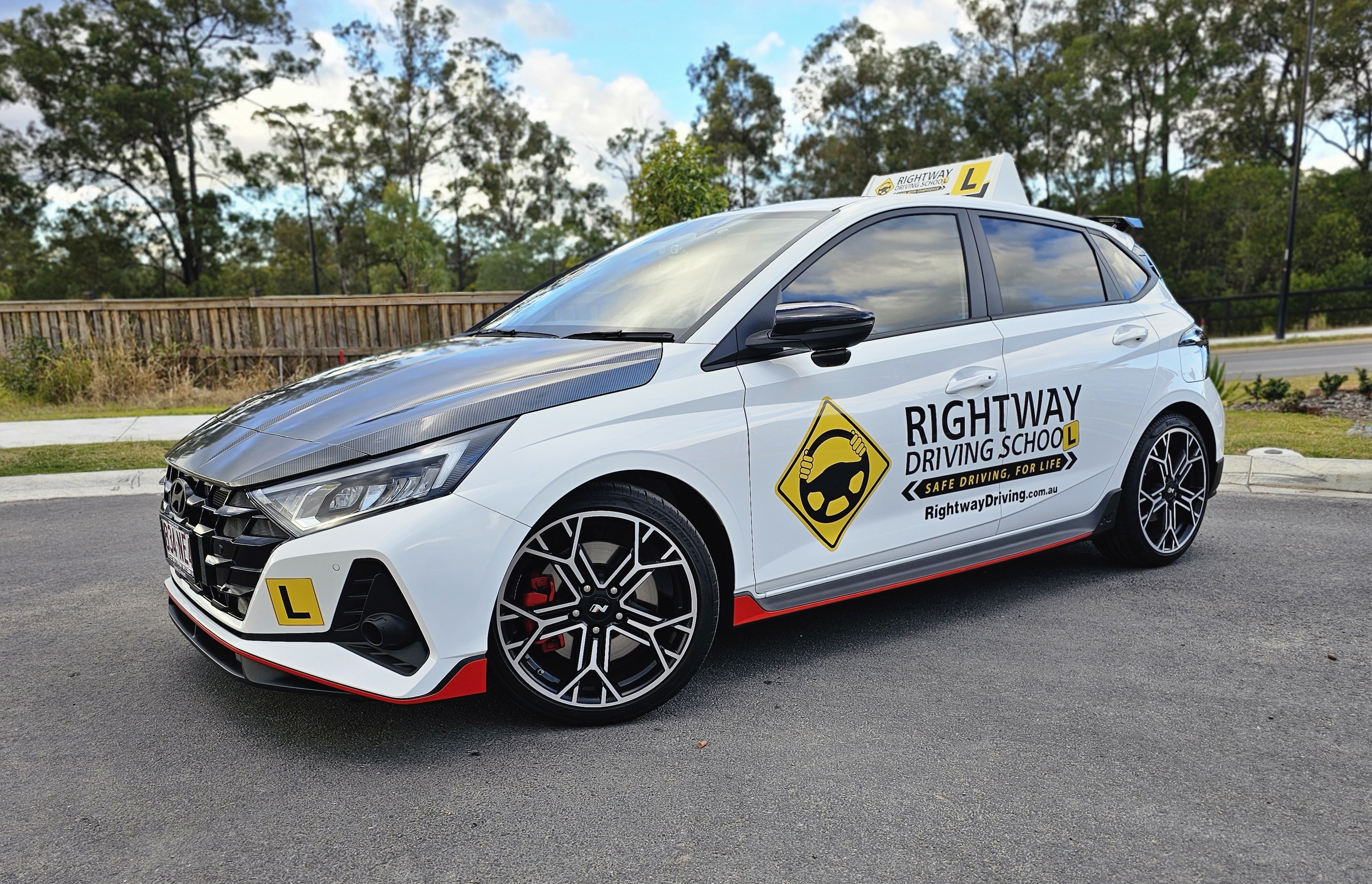 White Rightway driving school car with a learner roof sign