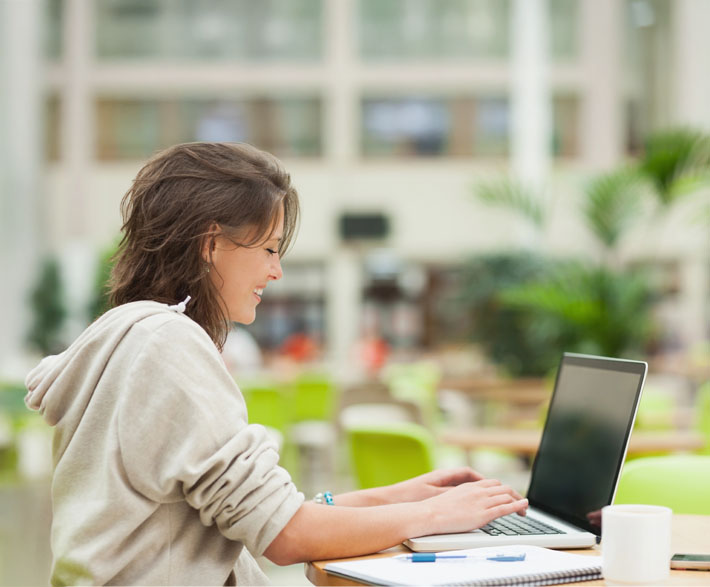 Happy student studying for comprehensive beginner driver education program with AAPEX Driving Academy.