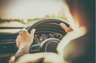 Hands on steering wheel.