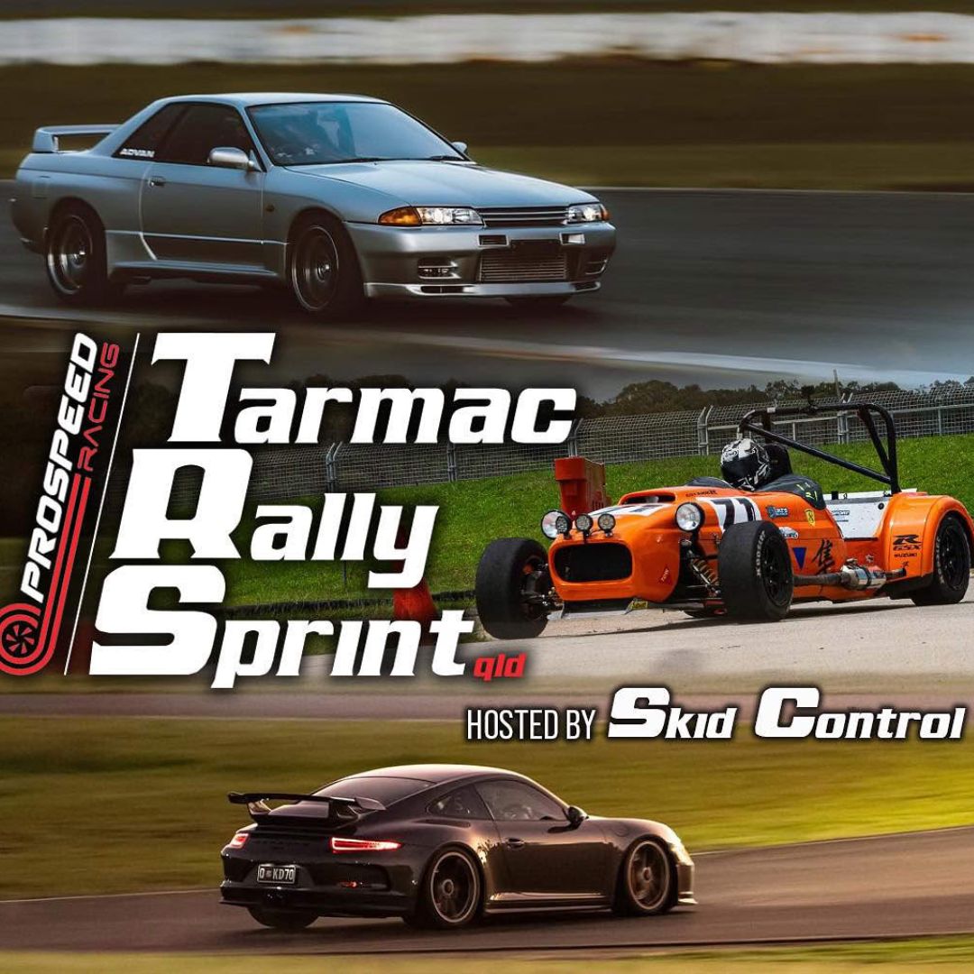 Black car at tarmac rally sprint track.