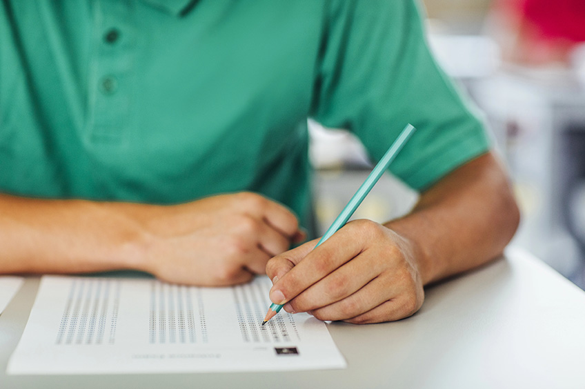Happy student studies in a classroom session.