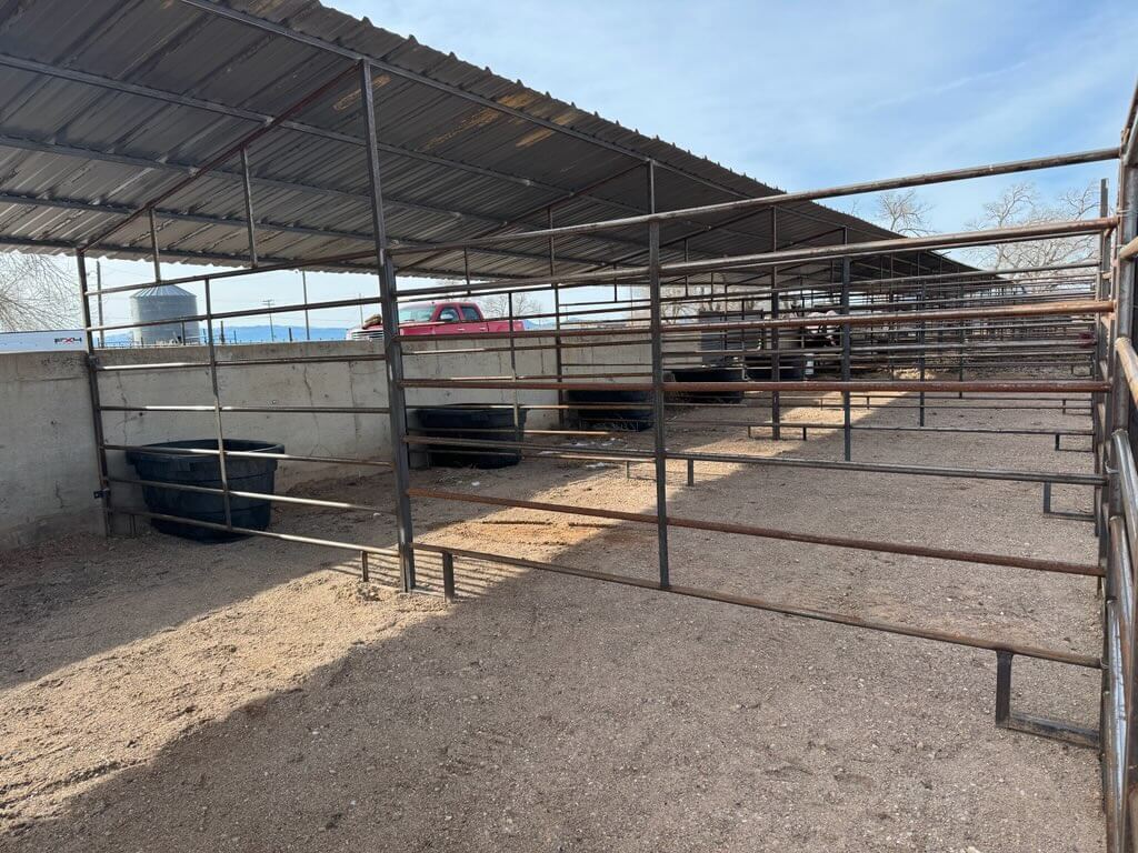 Empty pens with red truck.