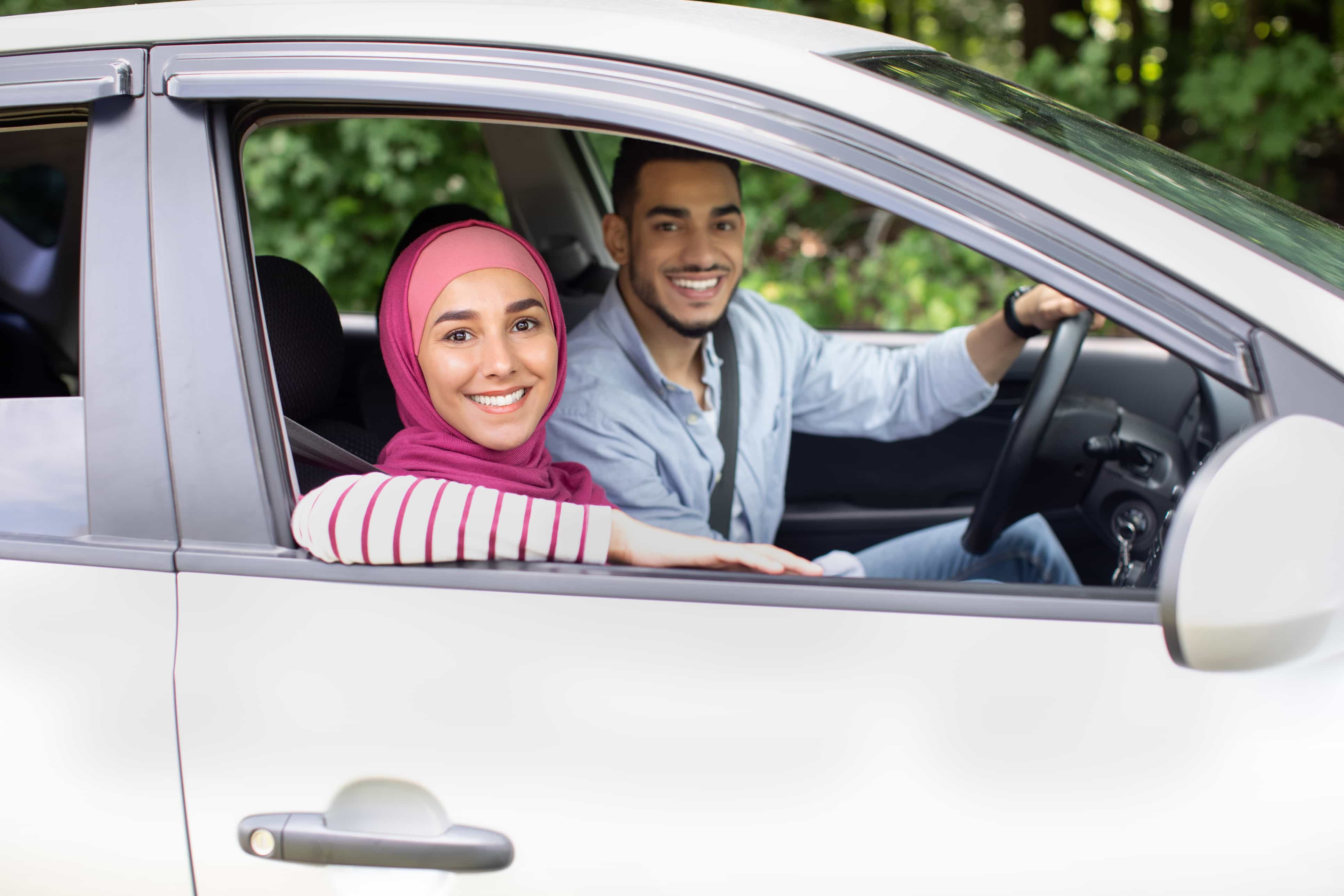 An instructor teaching a woman to drive