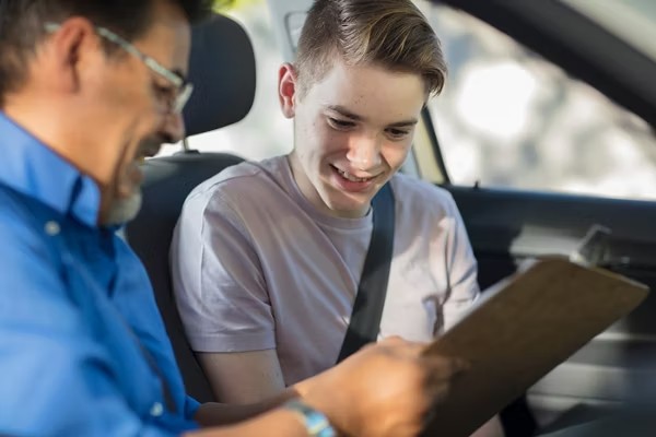 Teen student and AAA instructor during a behind-the-wheel driving lesson.