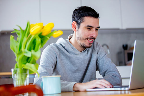Adult student managing their driving program enrollment on a laptop.