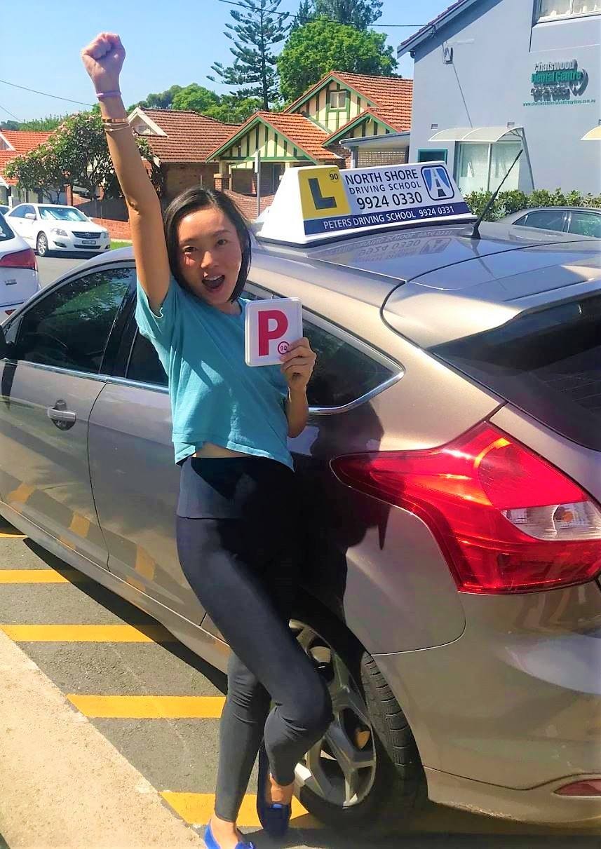 Student celebrating passing their NSW driving test &mdash; the reward of a driving instructor career at North Shore Driving School