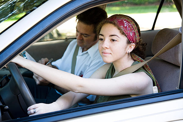 Teen driver in the driver's seat during a driving evaluation.