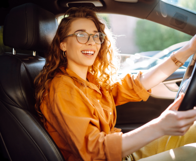 Teen driver smiling behind the wheel