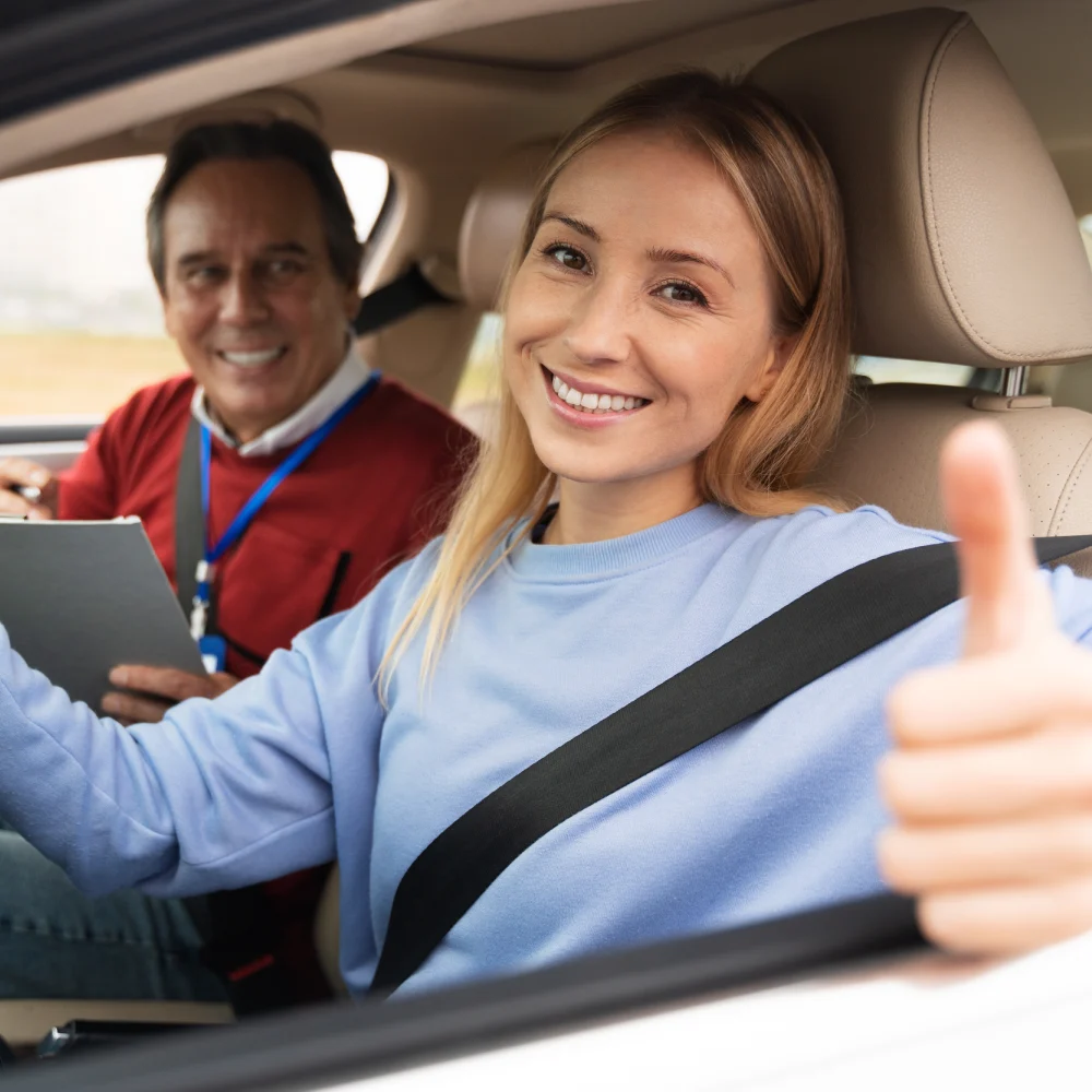 Adult driver giving a thumbs up after her lesson