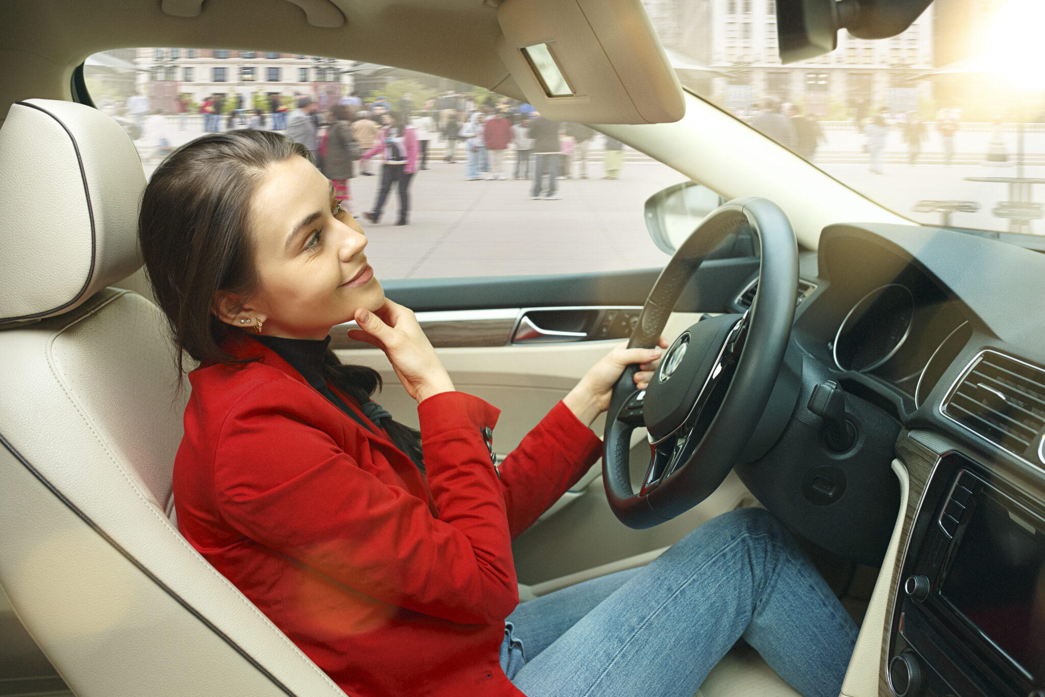 Smiling teen driver practicing behind the wheel during a driving lesson