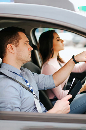 Driving instructor supervising a student during a lesson