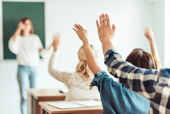 Instructor teaching a classroom of engaged students during a driver awareness class