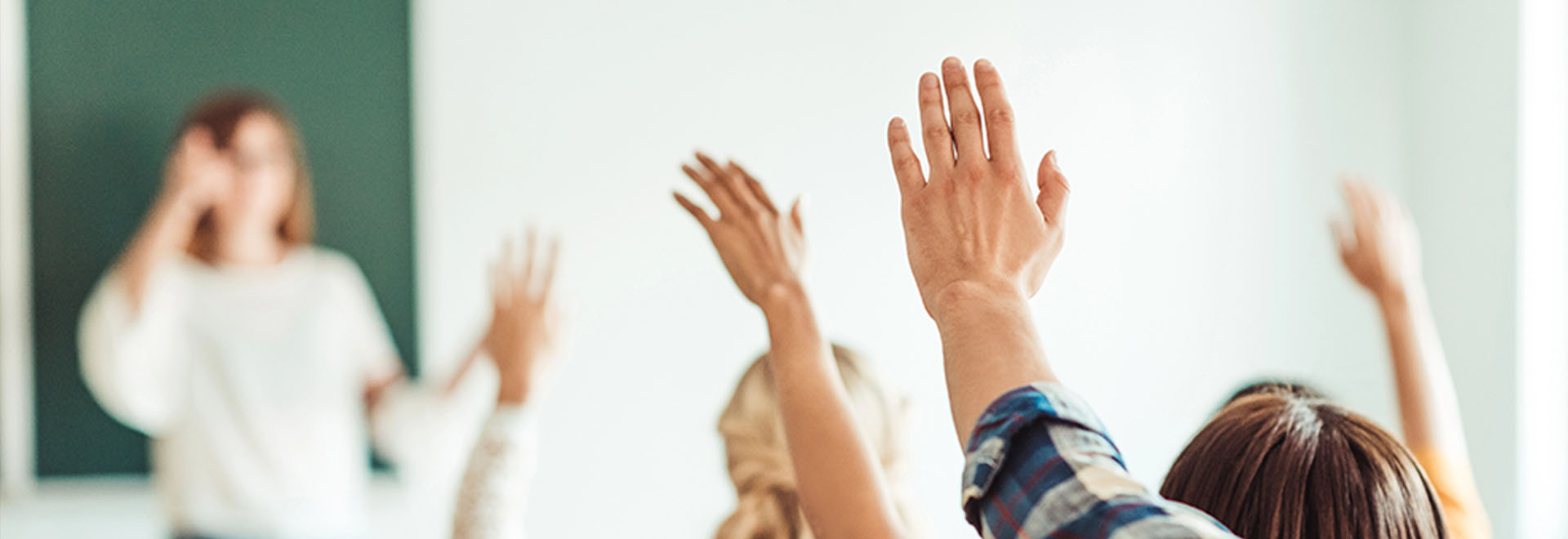 Students raising their hands during a Private RoadWise Group Class.
