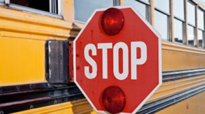 Stop sign on a school bus, representing AAA Western and Central New York traffic safety initiatives.