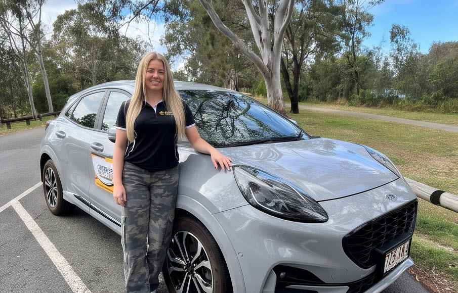 Sarah beside the Coastwide Driving School automatic Ford Puma