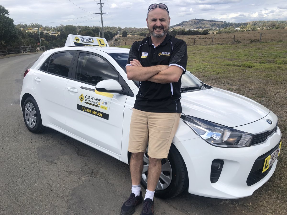 Coastwide instructor beside a white learner car
